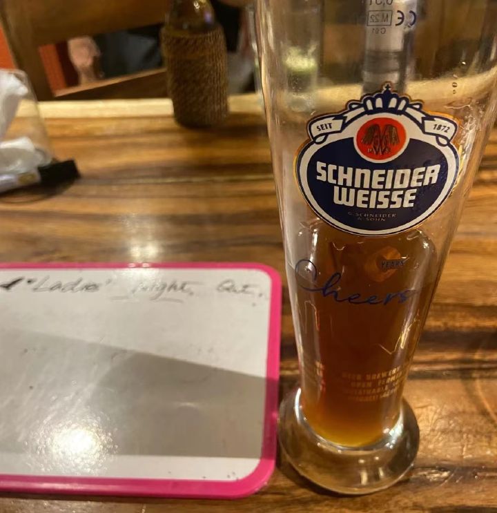 Drinking beer and answering questions on an acrylic board